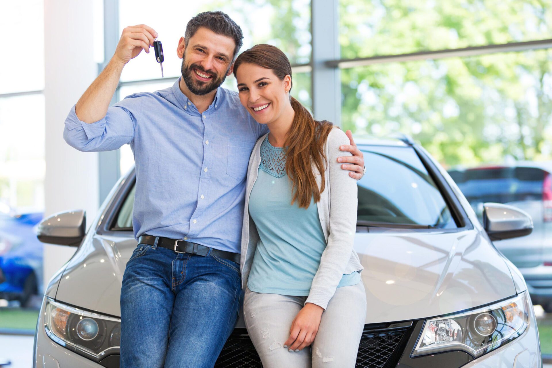 A couple that's happy after financing their new car 