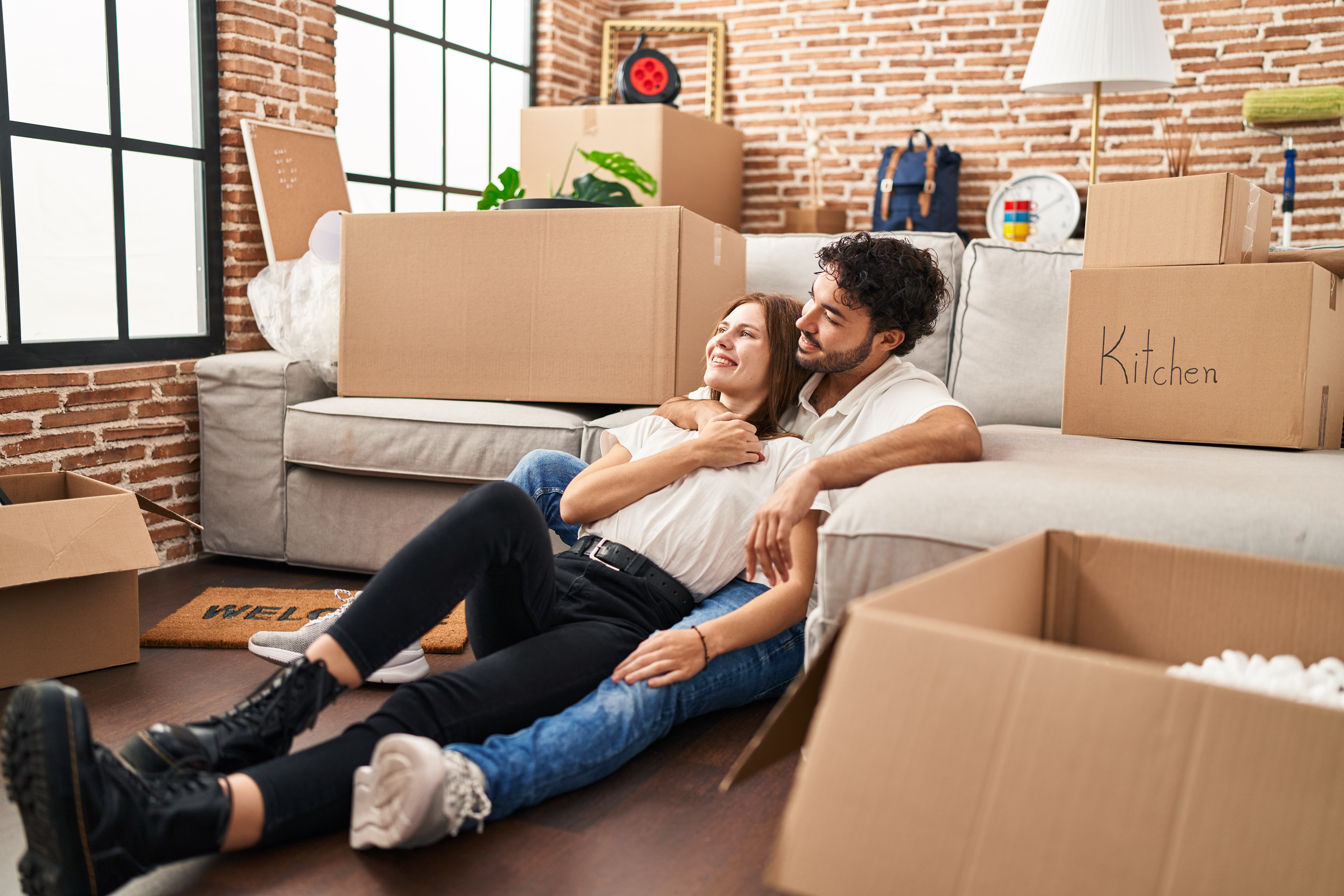 Couple in their new home; lenders mortgage insurance | Oceania Finance